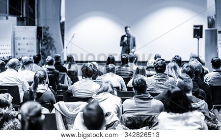 Male Public Peaker Giving Presentation On Business Conference Event.