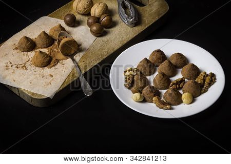 Homemade Chocolate Truffles Sprinkled With Cocoa. Walnuts And Mikadamia. Chocolate Truffles On A Dar