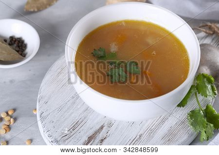 Soup With Meat, Peas And Carrots, Garnished With Herbs. Tasty Hot Soup.