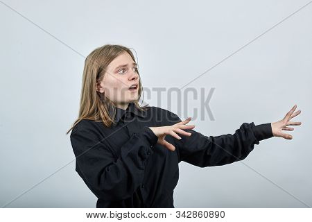 Disappointed Young Woman In Fashion Black Shirt Isolated On Gray Background In Studio Spreads Hands 