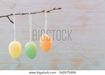 Easter Eggs On Branch In Sping On Wooden Vintage Background. Subtle Gentle Colored Eastern Decoratio