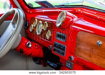 Bright Red Classic Antique Car Dashboard With Wooden And Golden Parts, White Leather Steering Wheel,