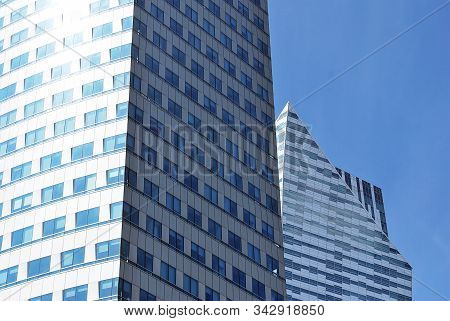 Geometric Reflection: Partly Cloudy Sky Reflected By Window Panes Of Office Building. Surface Of Gla