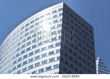 Geometric Reflection: Partly Cloudy Sky Reflected By Window Panes Of Office Building. Surface Of Gla