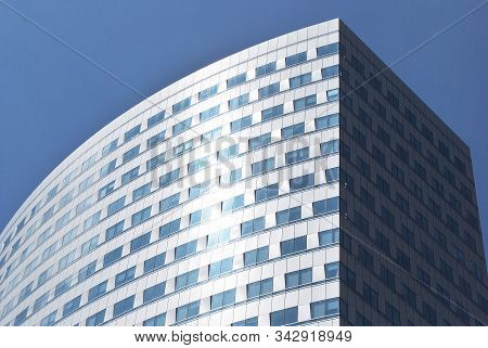 Geometric Reflection: Partly Cloudy Sky Reflected By Window Panes Of Office Building. Surface Of Gla