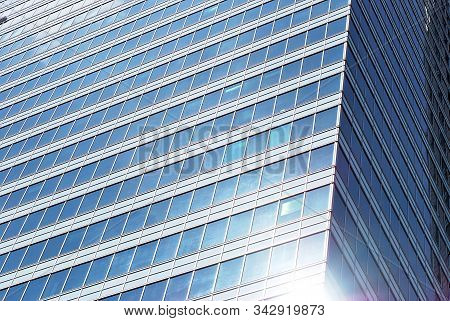 Geometric Reflection: Partly Cloudy Sky Reflected By Window Panes Of Office Building. Surface Of Gla