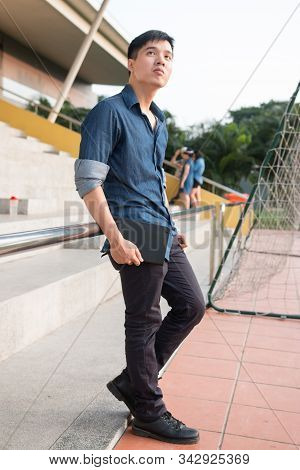 Handsome Guy Standing At Staicase With Hand In Pocket - Casual Fashion Style Of Asian Men In Vietnam