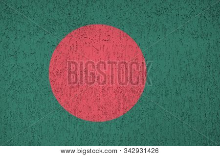 Bangladesh Flag Depicted In Bright Paint Colors On Old Relief Plastering Wall. Textured Banner On Ro
