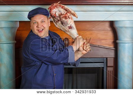 Half Legth Shot Of Thoughtful Male Chef, Holds Very Big Red Raw Piece Of Meat, Needs To Chop For Pre