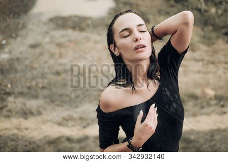 Sexy Beautiful Young Woman Enjoying Summer Rain. Attractive Brunette Woman Wearing Black Bodysuit An