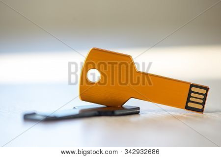 Close-up Of A Pen Drive, Flash Disk Sitting On A Disk Drive. Key Chain Shape.