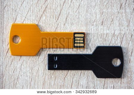 Close-up Of A Pen Drive, Flash Disk Sitting On A Disk Drive. Key Chain Shape.