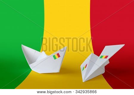 Mali Flag Depicted On Paper Origami Airplane And Boat. Handmade Arts Concept