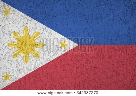 Philippines Flag Depicted In Bright Paint Colors On Old Relief Plastering Wall. Textured Banner On R