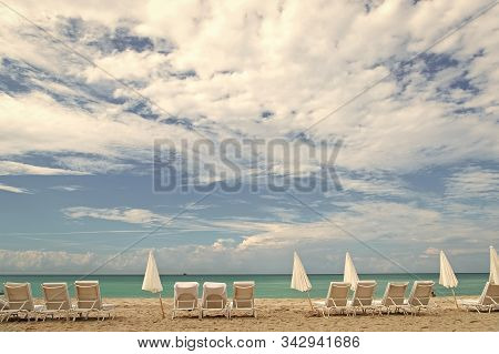 Find Great Values In Glitzy South Beach. Miami South Beach. Sunbeds And Umbrellas On Sandy Beach. Fl