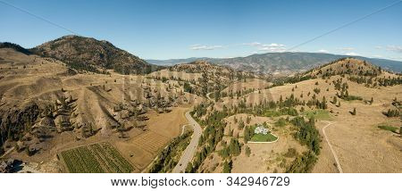 Aerial View Of A Scenic Road In The Dry Canadian Mountain Landscape During A Sunny Summer Day. Taken