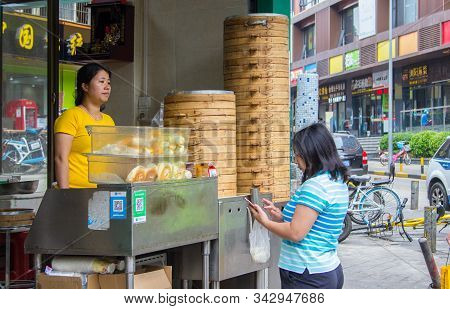Shenzhen, China - November 14 2018: A Female Customers Uses Smartphone To Pay Jer Breakfast Purchase