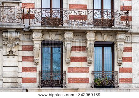 Facade Of A Historic Brick Building With Metal Balconies. Geneva, Switzerland - Image