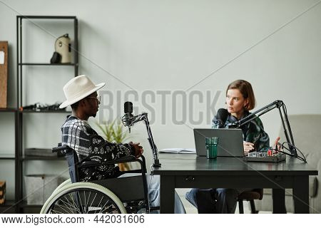 Portrait Of African-american Person With Disability Speaking To Microphone While Recording Podcast I