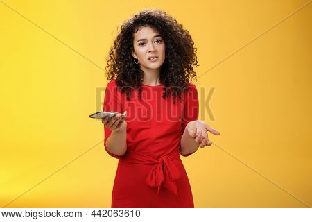 So Waht, I Confused. Questioned Uncertain Woman With Curly Hair In Red Dress Shrugging Looking Cluel