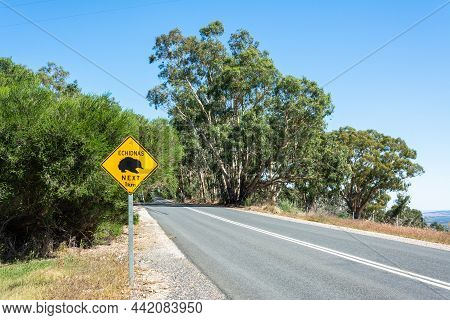 'echidnas Crossing. Next 1km' Road Sign In Australia.