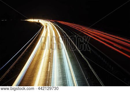 Moving Cars At Night On Highway, Long Exposure. Motion Blur Effect Of Light Trails. Fast Speet Traff
