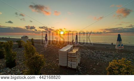 Batumi, Georgia - September, 2021: A Beautiful View Of Western Georgia, Sun Setting In The Sea, Pebb