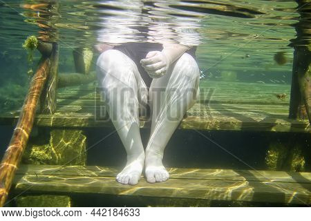 Fat Woman Immersed In The Sea To Combat Depression And Celulitis. Seawater Helps To Lose Weight