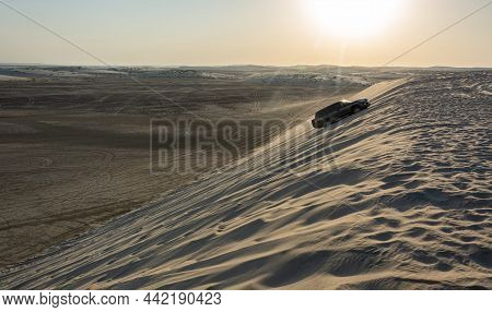 Khor Al Adaid, Qatar - November 5, 2016. 4wd Vehicle Driving Up A Sand Dune In Khor Al Adaid Desert 