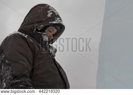 A Portrait Of A Fitter With A Hood On His Head