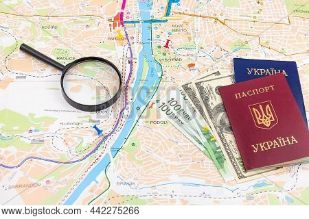 Travel Arrangement With Dollars, Euro, Two Passports And Magnifying Glass On A Map Background. Trave