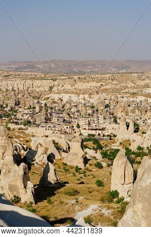 Cappadocia, Turkey - 20 July 2021. Day View Of Goreme Town With Blue Clear Sky On Horison. Famous Ce