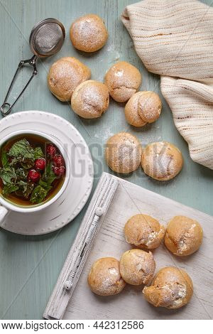Delicious Profiteroles With Whipped Cream Sprinkled With Powdered Sugar