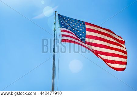 American Travel Destinations. National  American Flag On Pole Against Blue Sky In Arizona In The Uni