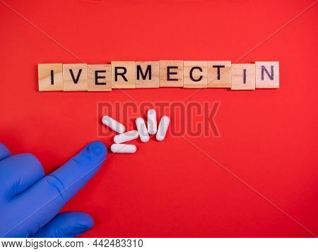 Ivermectin On Colored Red Paper Texture Background. Ivermectin Antiparasitic Medication. Off Label A