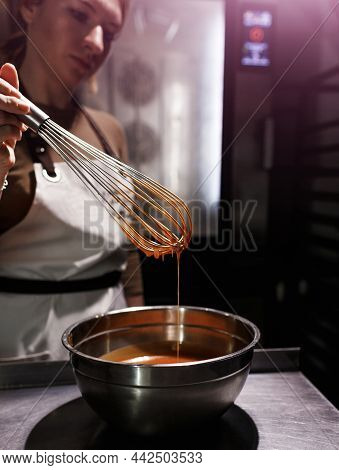 A Chef Girl Whips Melted Chocolate In A Bowl With An Old Metal Wire Close-up On Her Hand And Dishes