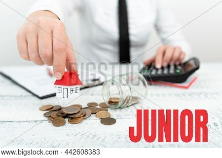 Handwriting Text Junior. Concept Meaning Erson Who Is A Specified Number Of Years Younger Than Someo
