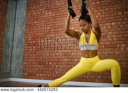 Attractive Woman Doing Glute Exercises, Performing Side Lunges While Working Out With Suspension Str