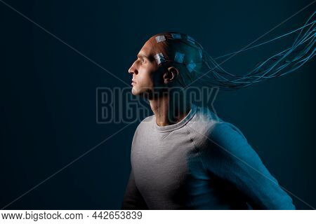 A Young Man With His Head Entangled With Wires, A Portrait In Profile, Electrical Contacts On His Ba