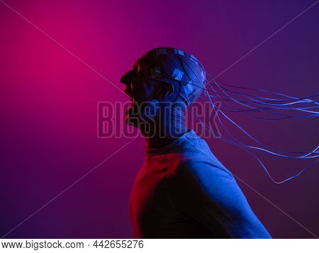 A Young Man With His Head Entangled In Wires, Screaming, Electrical Contacts On His Bald Head, Signa