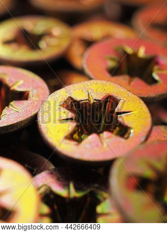 Anodized Screw Caps Close-up. A Vertical Vivid Illustration On The Theme Of Hardware And Fasteners. 