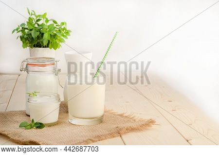Dairy Starter Culture For The Preparation Of Fermented Milk Products In A Glass On A White Wooden Ba
