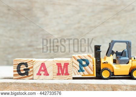 Toy Forklift Hold Letter Block P In Word Gamp (abbreviation Of Good Automated Manufacturing Practice