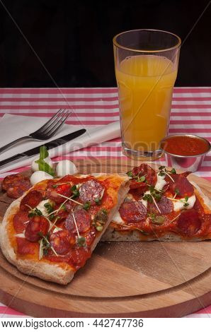 Classic Italian Pizza With Chorizo And Mozzarella And Orange Juice