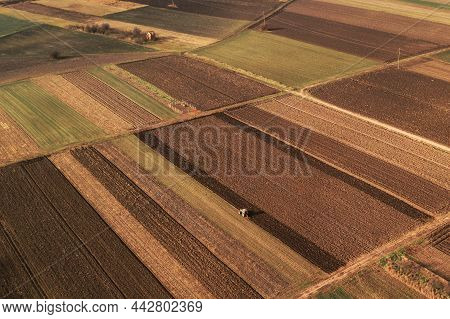 Aerial View Of Farmland Field Tillage With Tractor, Drone Photography