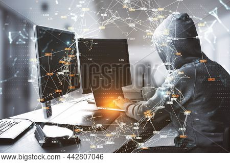 Hacker At Table Using Computers With Creative Glowing Big Data Connections Circle On Blurry Interior