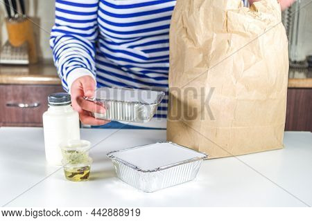Caucasian Woman Take Apart Package With Heat-and-eat Meal Boxes From The Restaurant. Takeout Order D