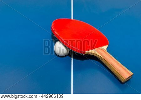 Paddle, Tennis Ball On Blue Ping Pong Table Close Up.blue Table Tennis Or Ping Pong.selective Focus.