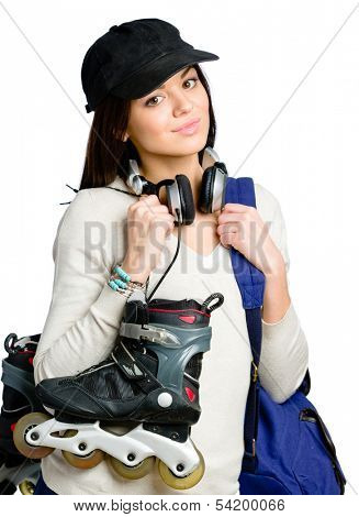 Half-length portrait of teenager keeping roller skates and wearing peaked cap, blue rucksack and earphones, isolated on white