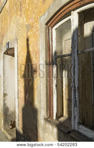 An old window and door that are glowing in the late afternoon sun
